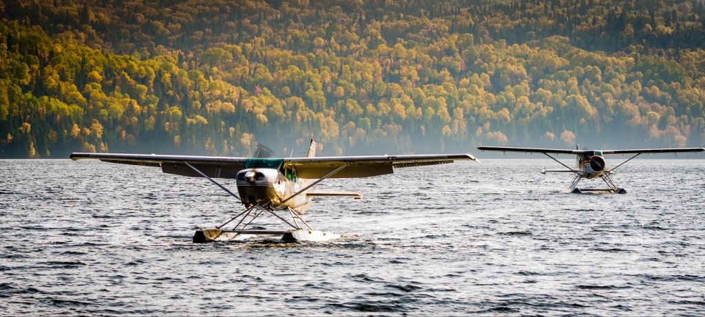 Two airplanes landing on a lake