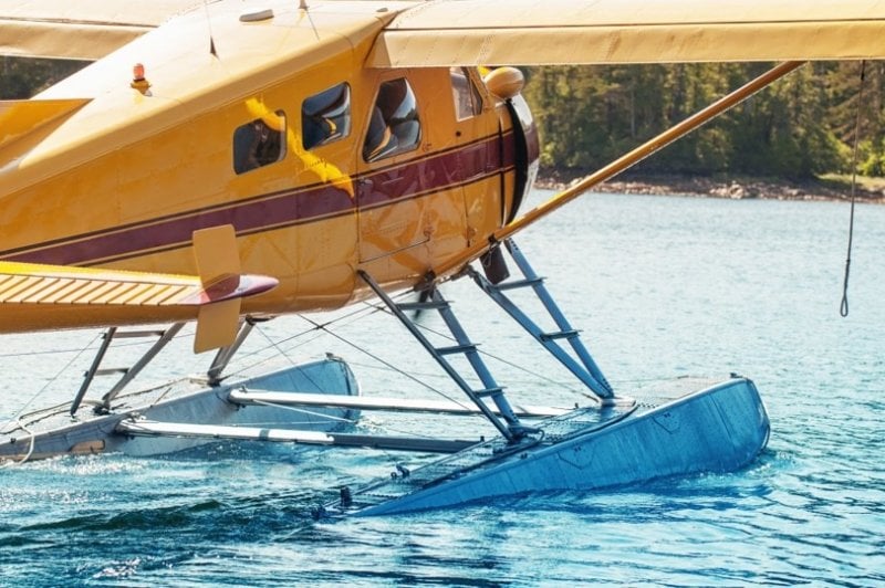 Close up of sea plane landing on water.