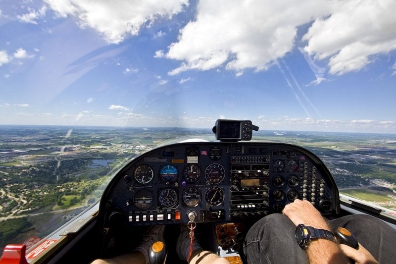 Close up of the inside console of a plane while it is flying.