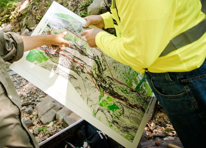 Two people out in the field looking at a map.