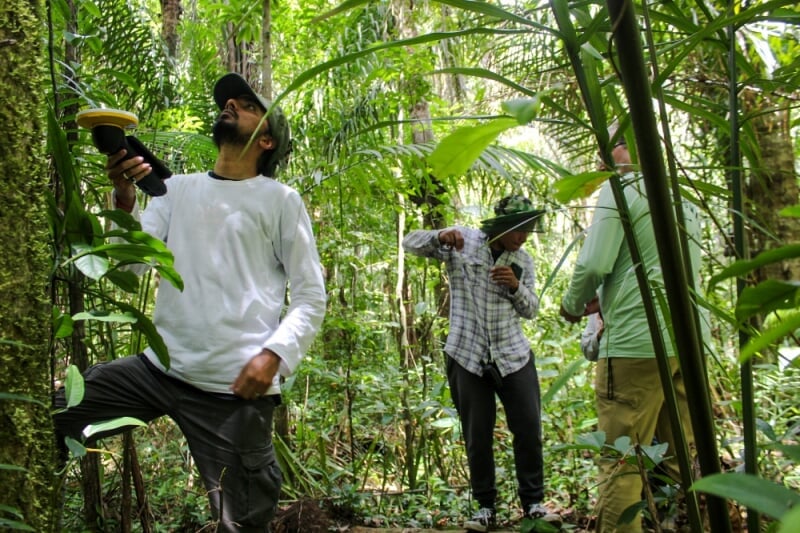 Parth Bhatt in a forest in Suriname while controlling a drone.