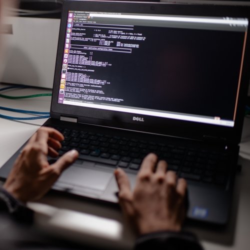 Guy on a keyboard, checking code.