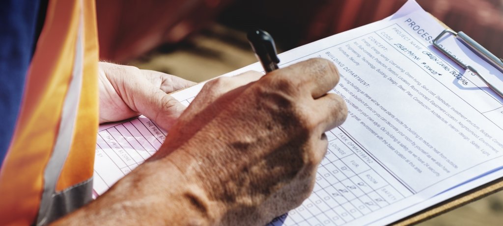 Researcher filling out a form on a clipboard