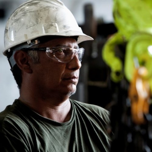 Engineering wearing safety hat and goggles while working in industry.