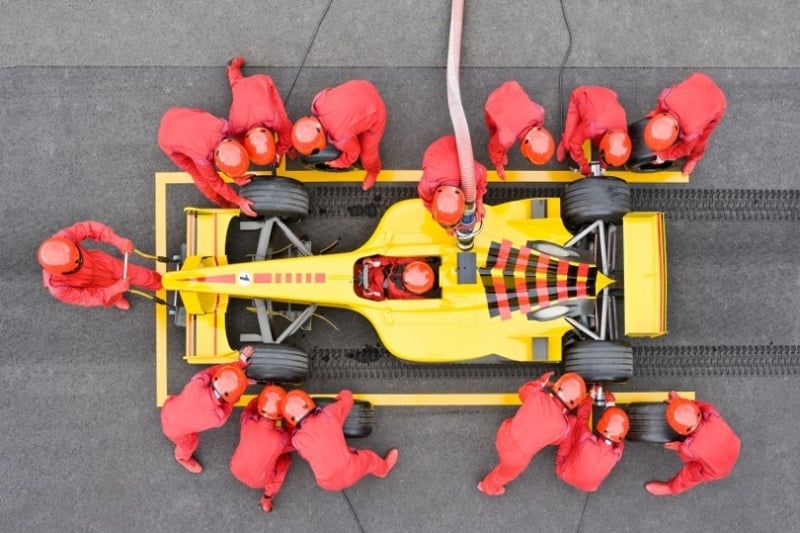 Race car being worked on by a team.