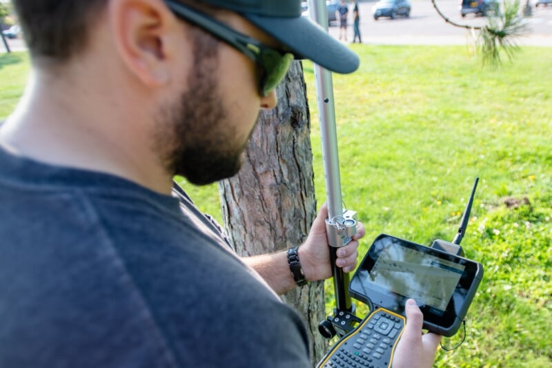 Young engineer doing survey work outside.