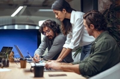 Three young professionals making a decision at a meeting.