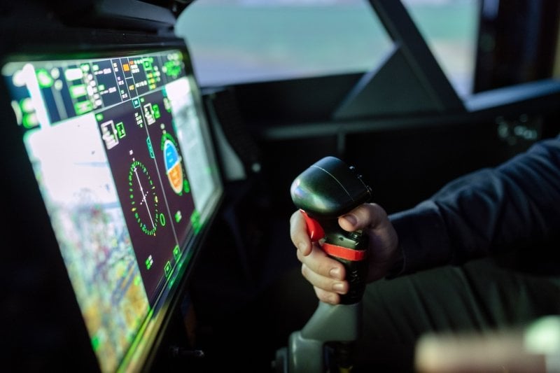 Close up of an engineer's hand operating a controller in an electric vehicle.