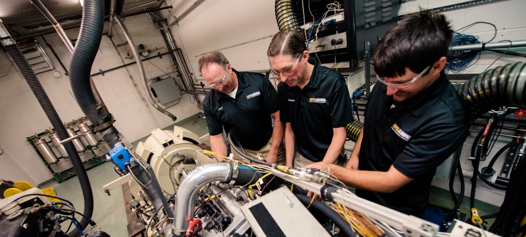 Mechanical engineering students and faculty in a lab.