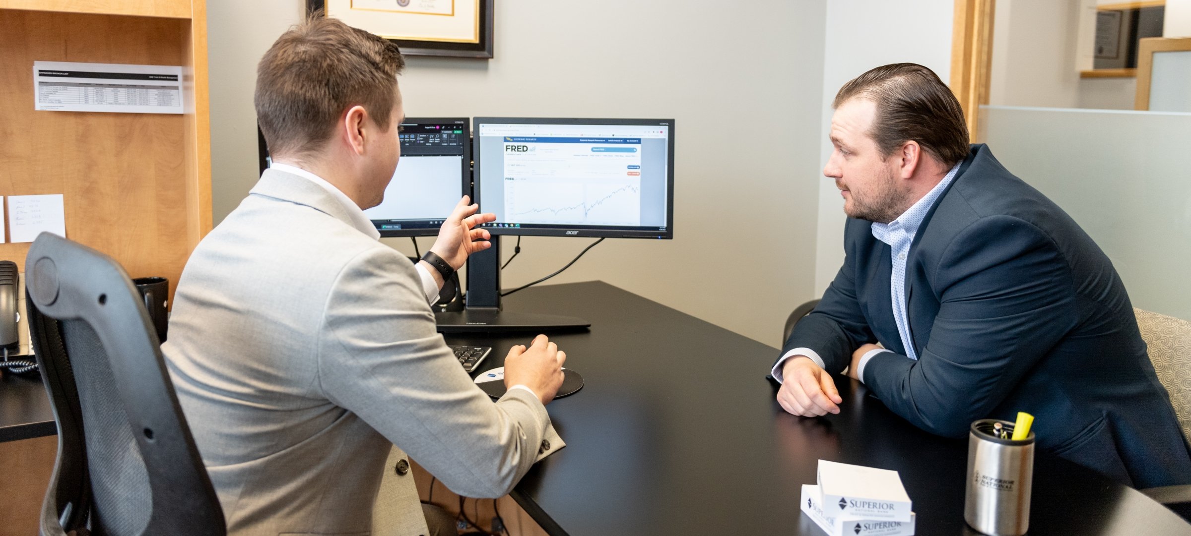 A graduate with a TechMBA consulting with a supervisor.