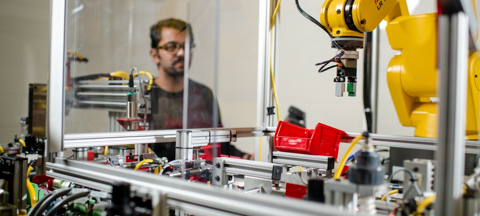 Young professional working in a robotics lab.