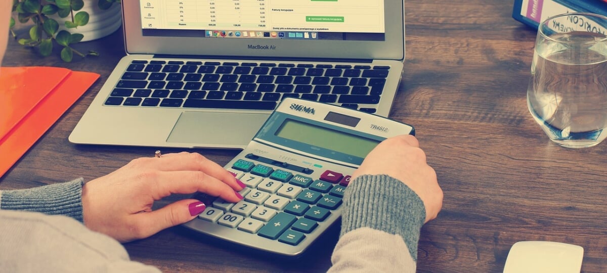 Someone using a calculator to figure out expenses.