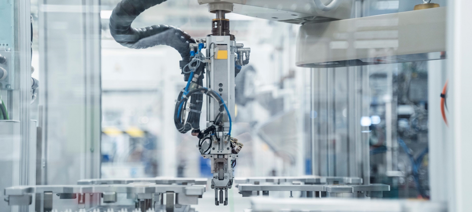 Close up of a robotic machine in a sterile modern factory.