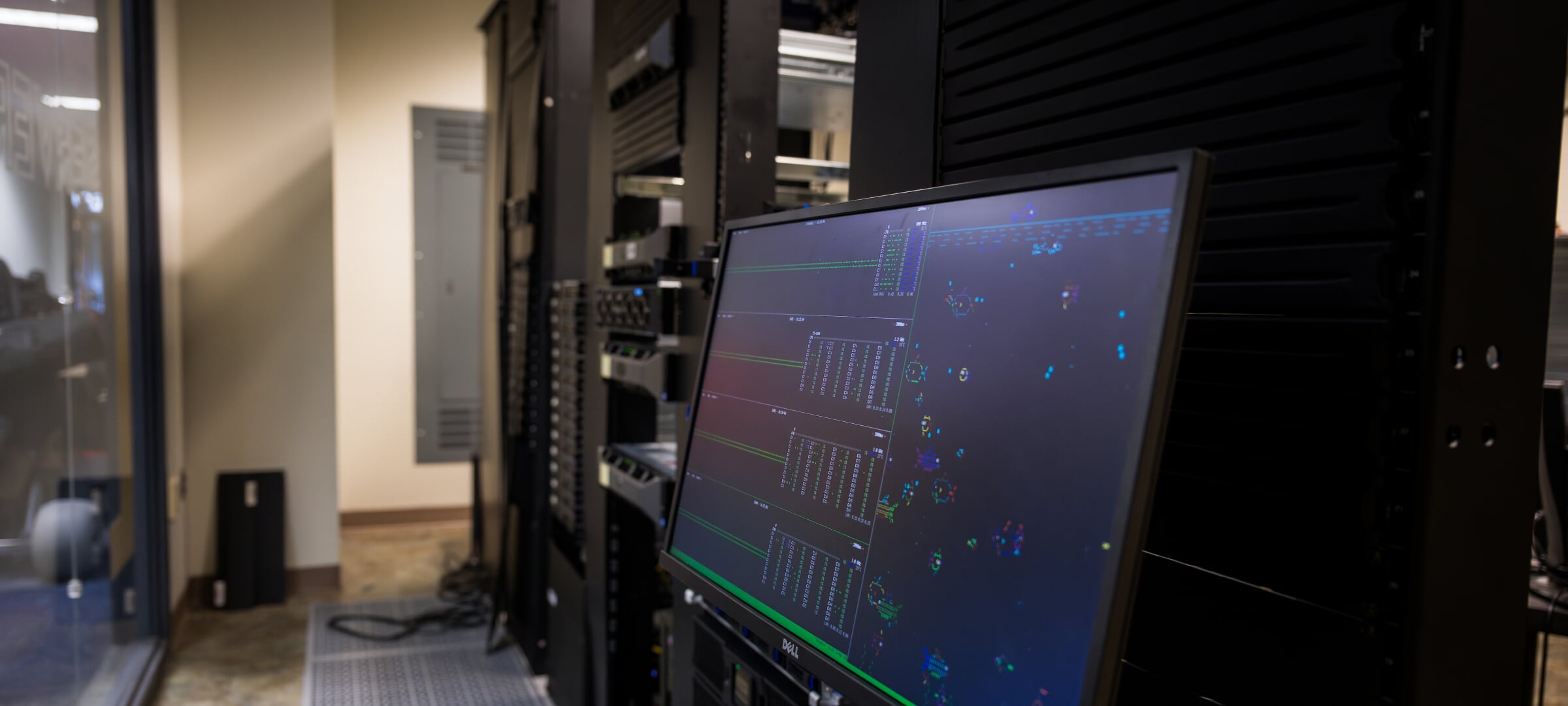 Computer in a server room displaying data and charts.
