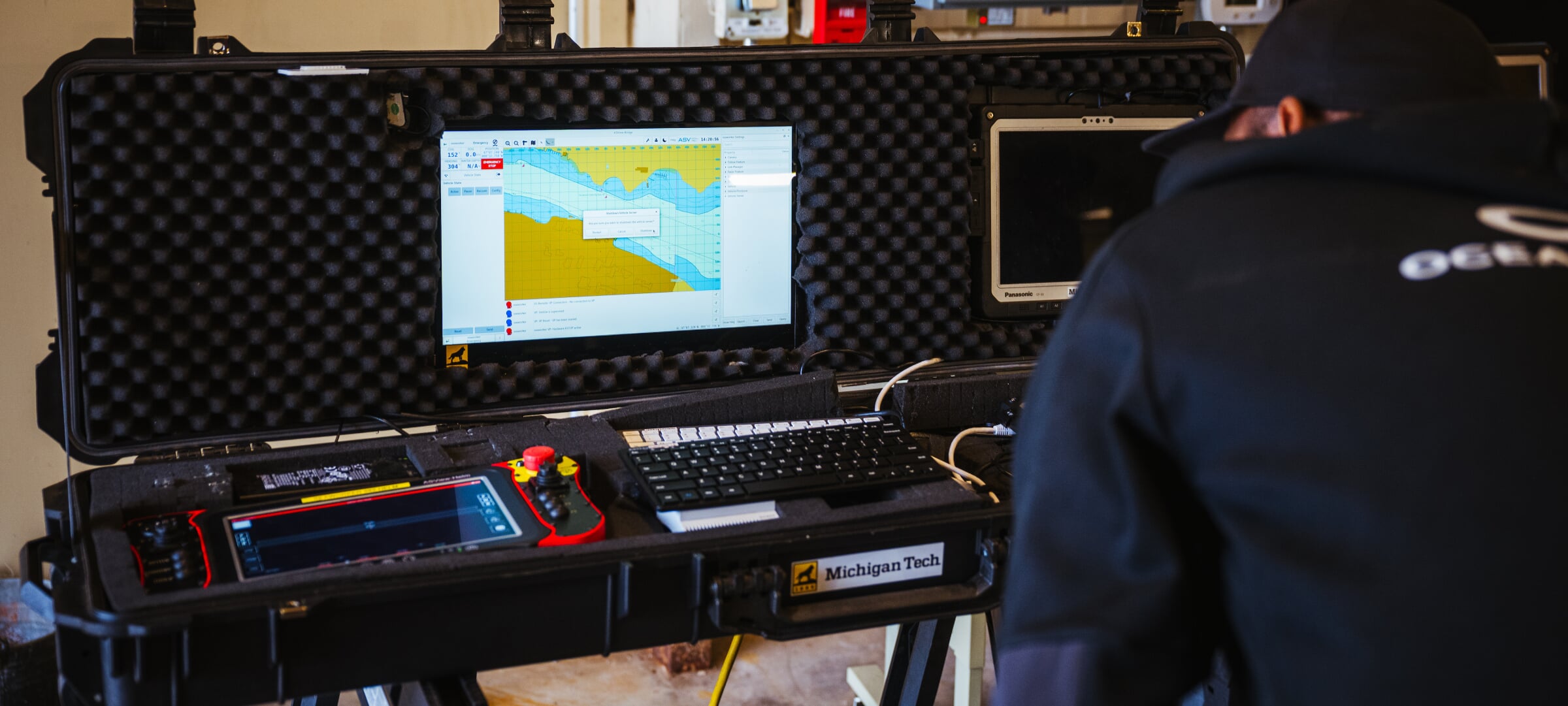 A laptop in a case displays underwater imaging information to a researcher.