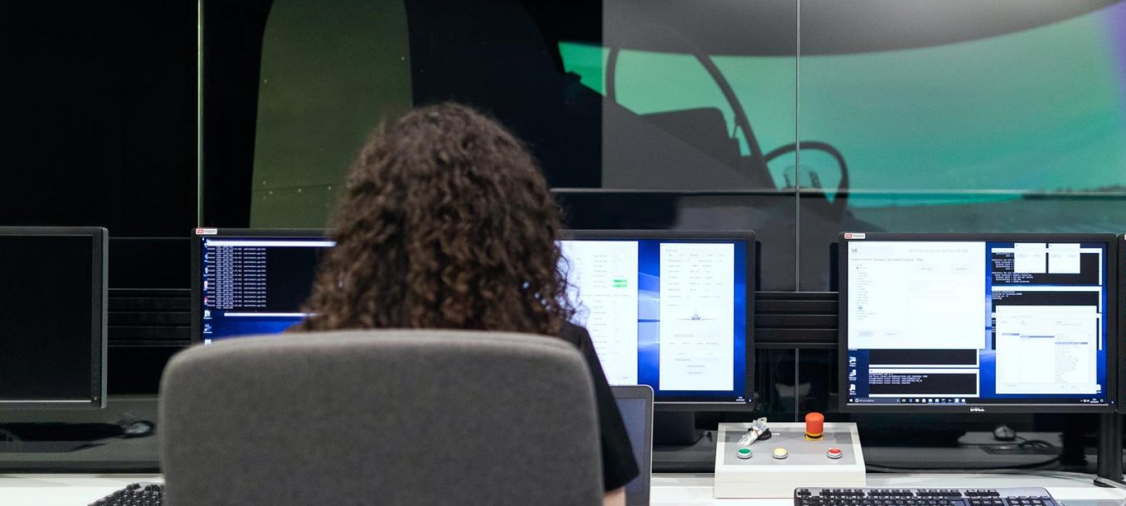 Student learning online; she has multiple computers in front of her.