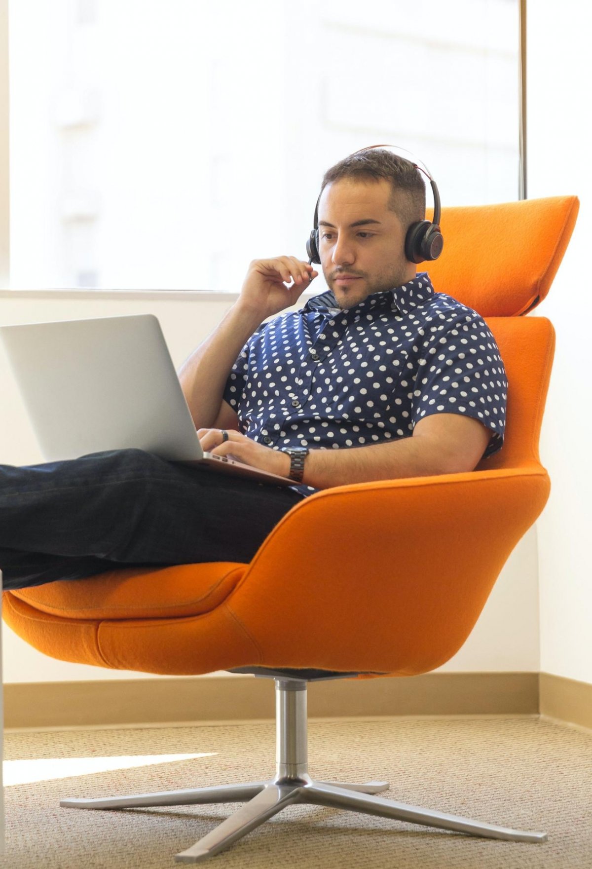 Young man working on his online course in an office area.