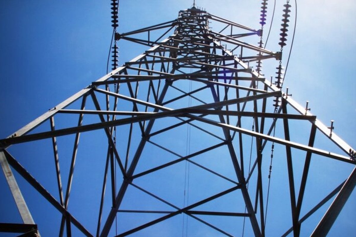 Power tower against a bright blue sky