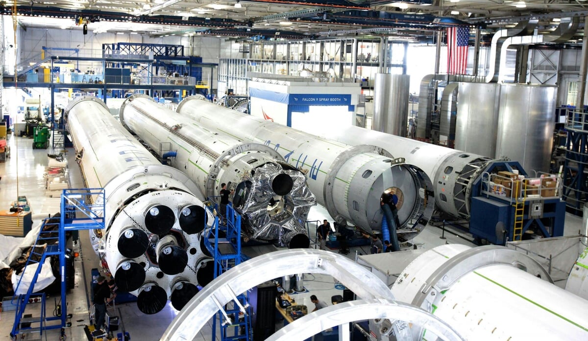 A warehouse/factory containing several rocket thrusters that are lying on their side.