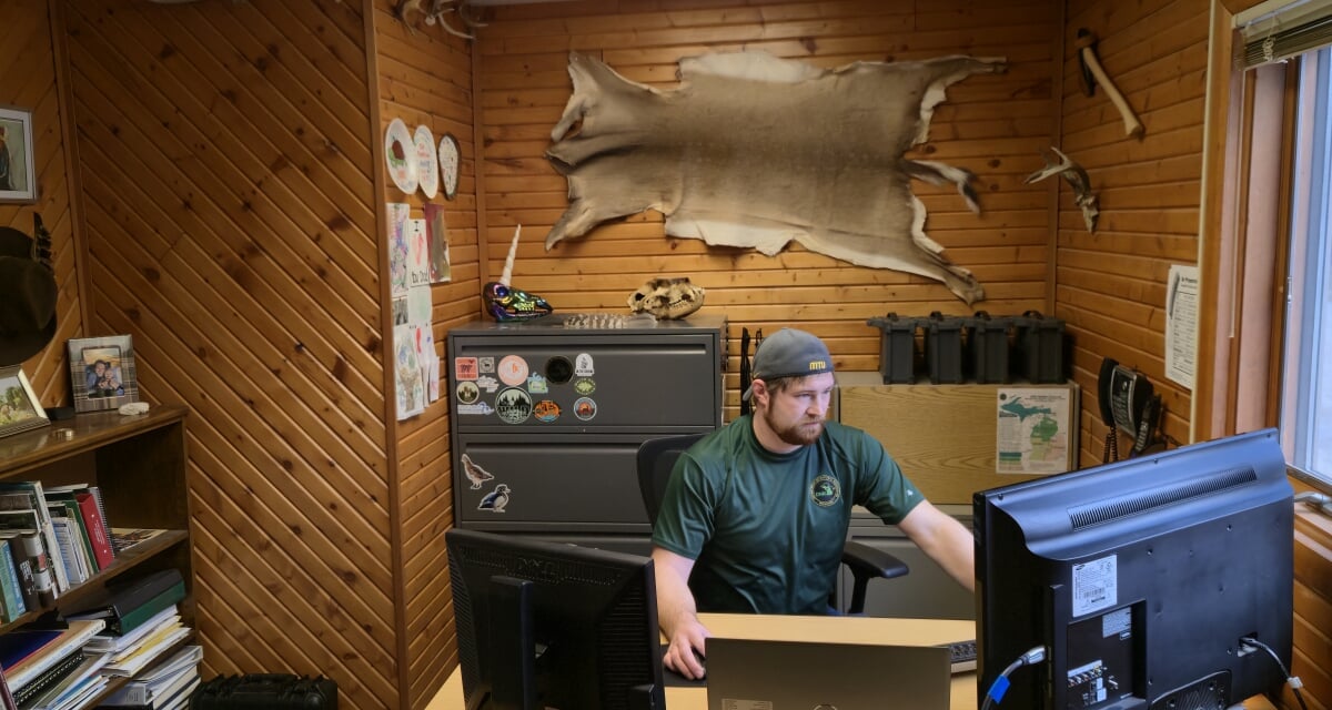 James Miller working at his desk in the Michigan DNR.
