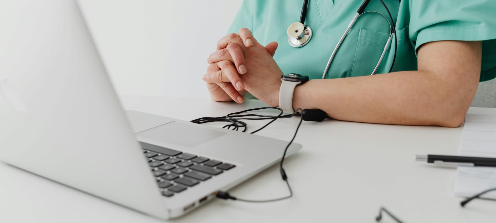 A doctor looking at medical records on her laptop