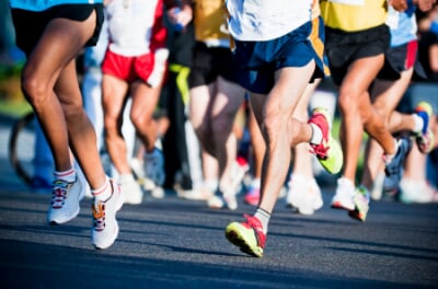 Close-up of runners' legs at the start of a marathon.
