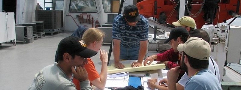 students pouring over calculations in engineering lab