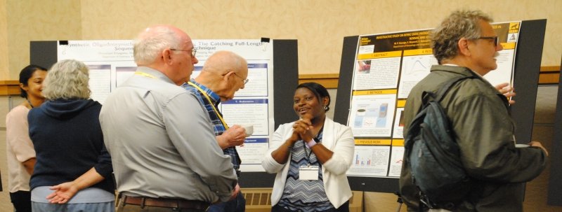 Graduate student presenting to alumni at President's Breakfast