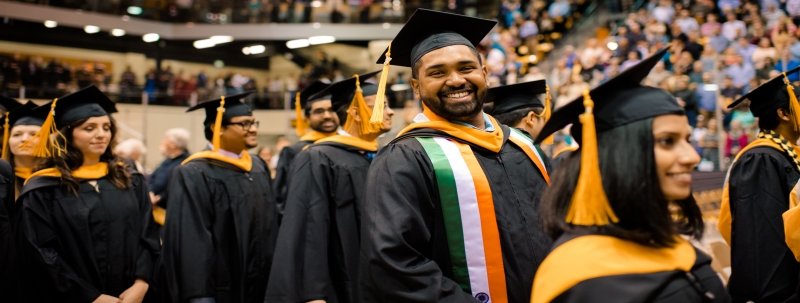 Master's degree students smiling after hooding