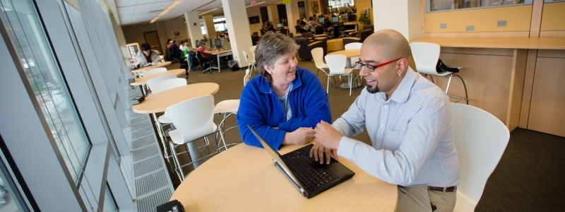 staff helping student with writing dissertation