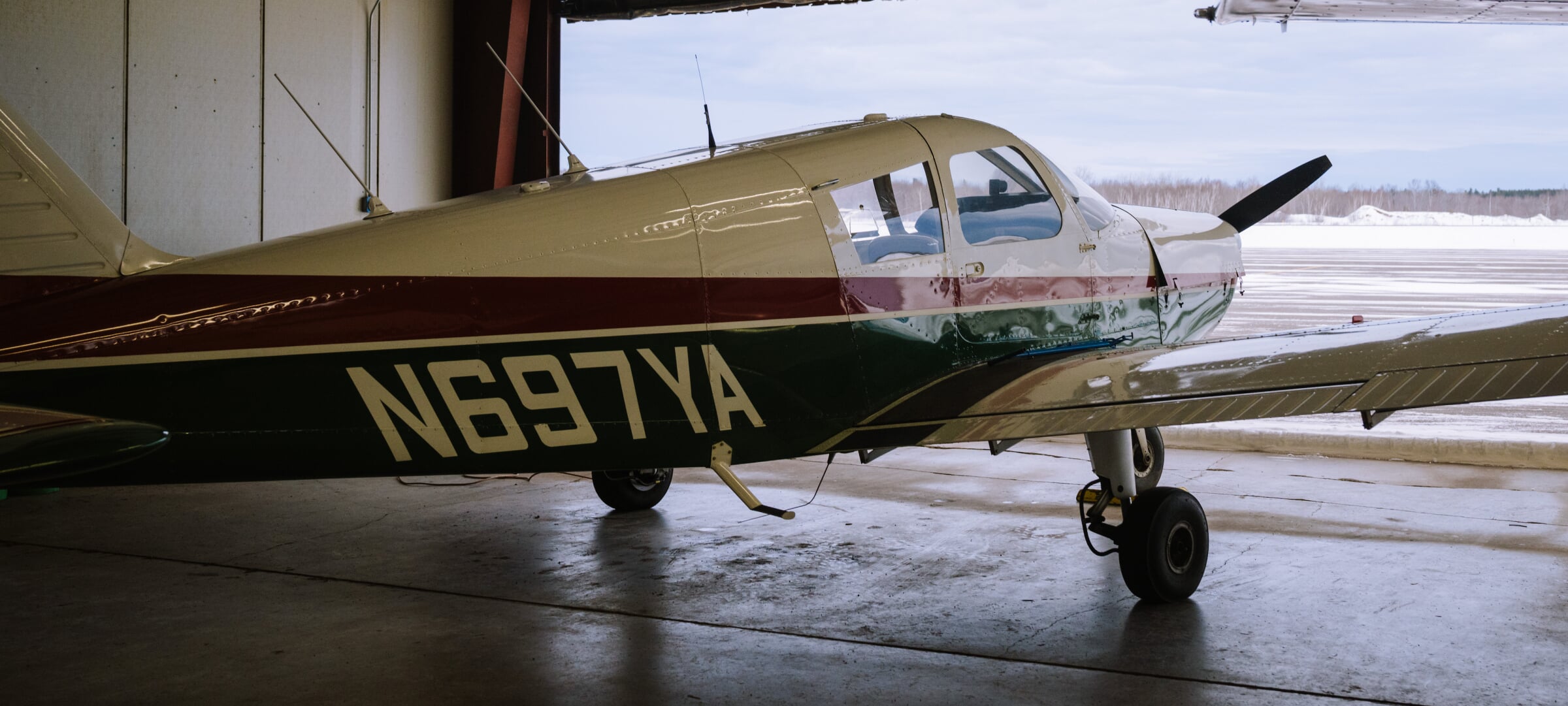 A small prop plane sitting in a hangar.