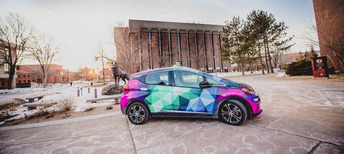 Hybrid Electric Vehicle in front of the Husky Statue.