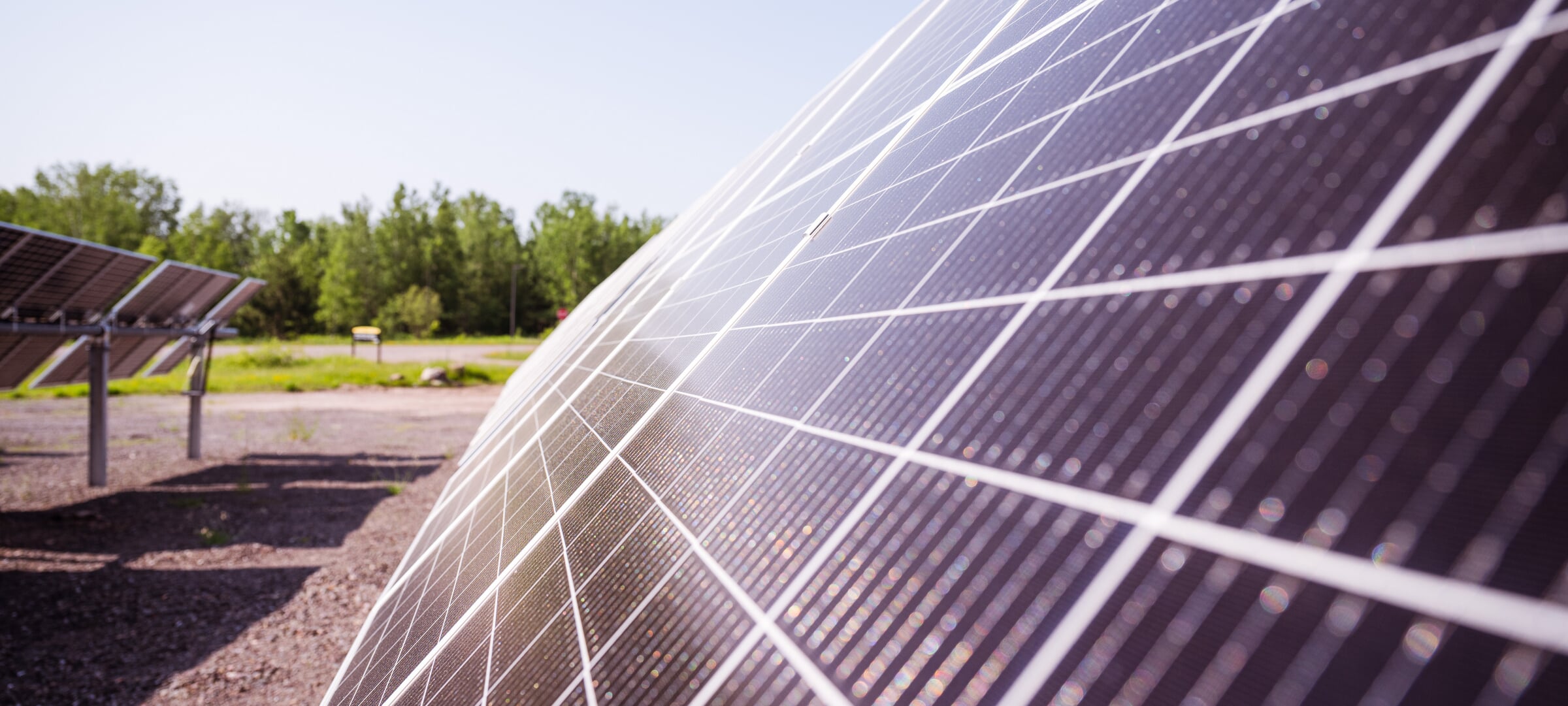 Closeup of solar panels in a sunny solar farm.