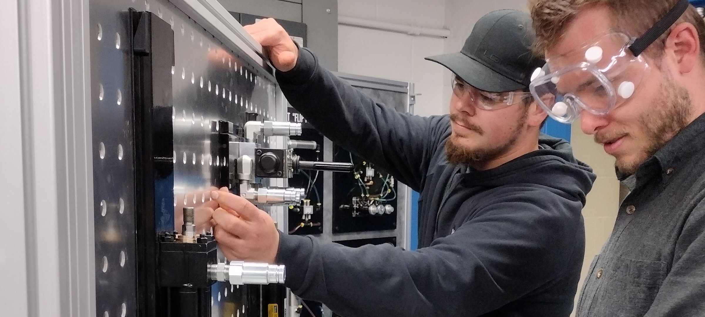 Two grad students inside Applied Fluid Power Lab working