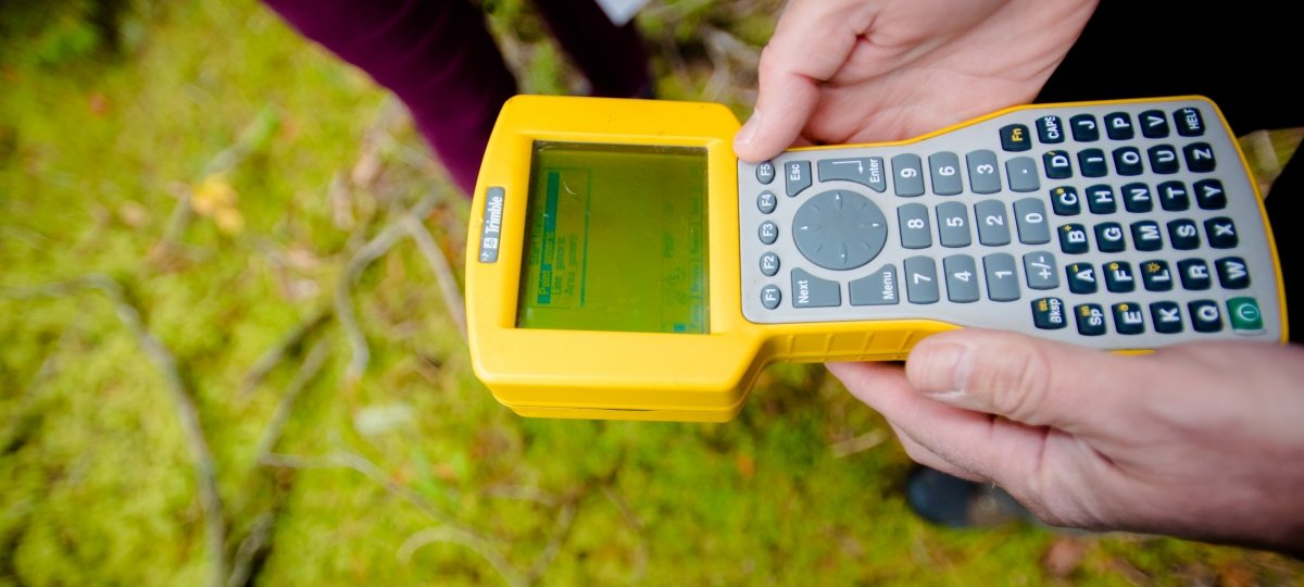 Researcher holding a device to measure seismic activity