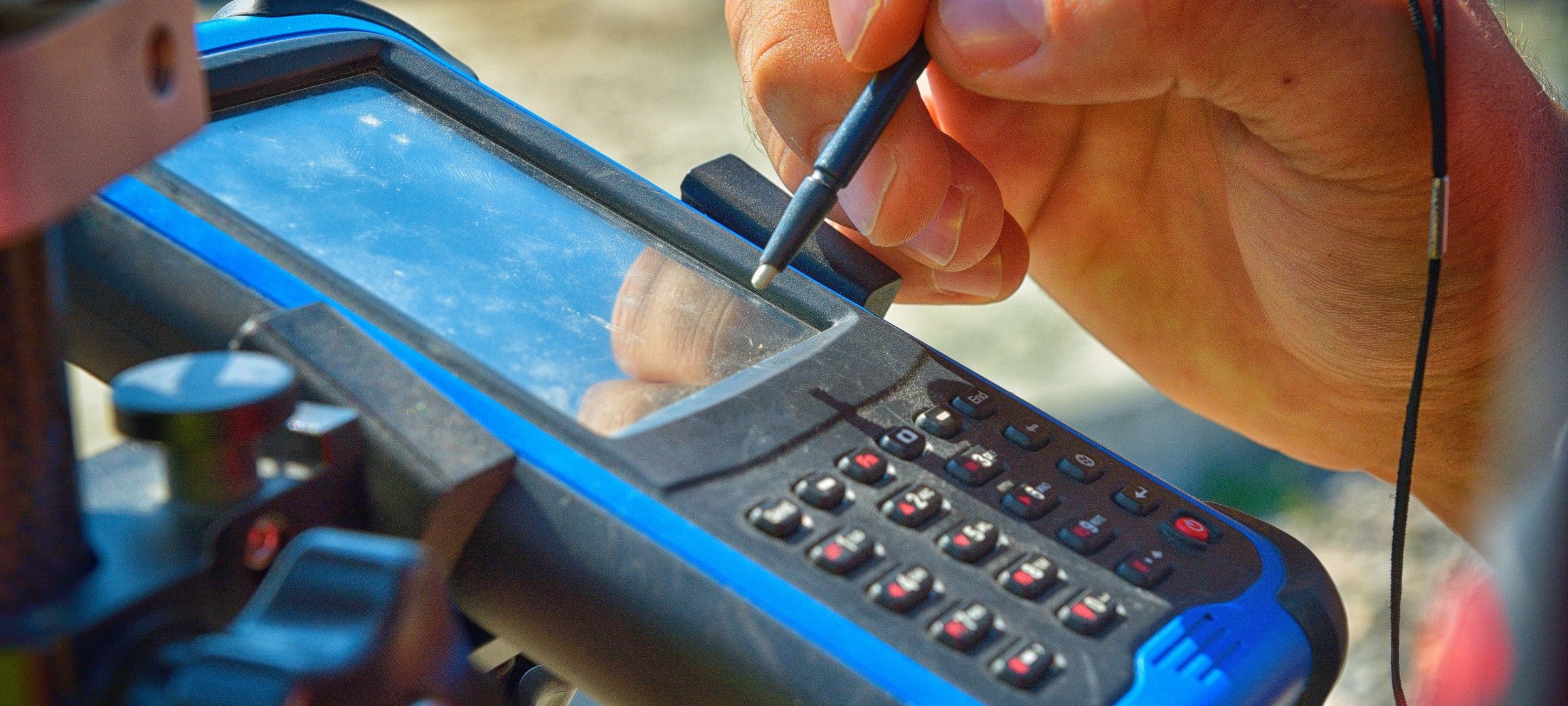 Researcher using a  GPS surveying instrument.