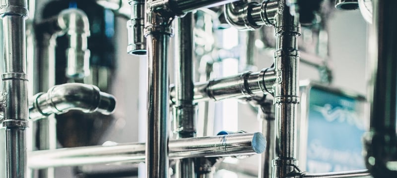 Steel pipes in a lab with a computer to monitor.