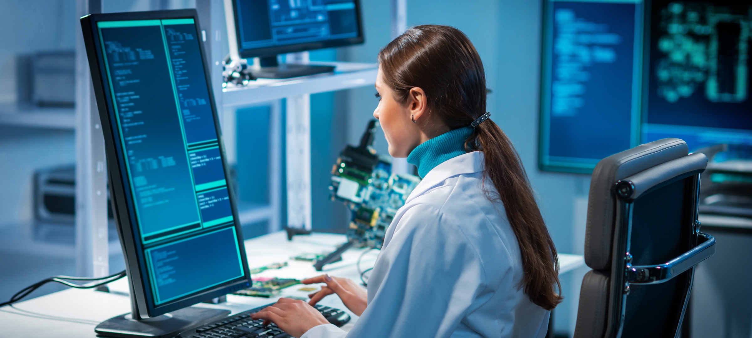 Research writing code in a lab and lab coat.