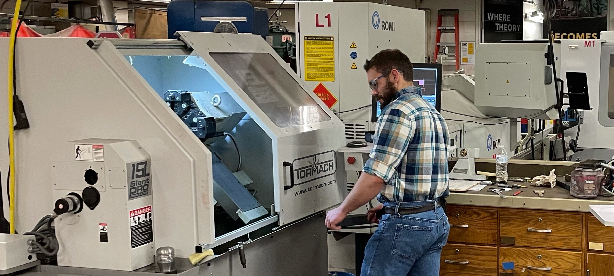 Graduate student working in a manufacturing laboratory.