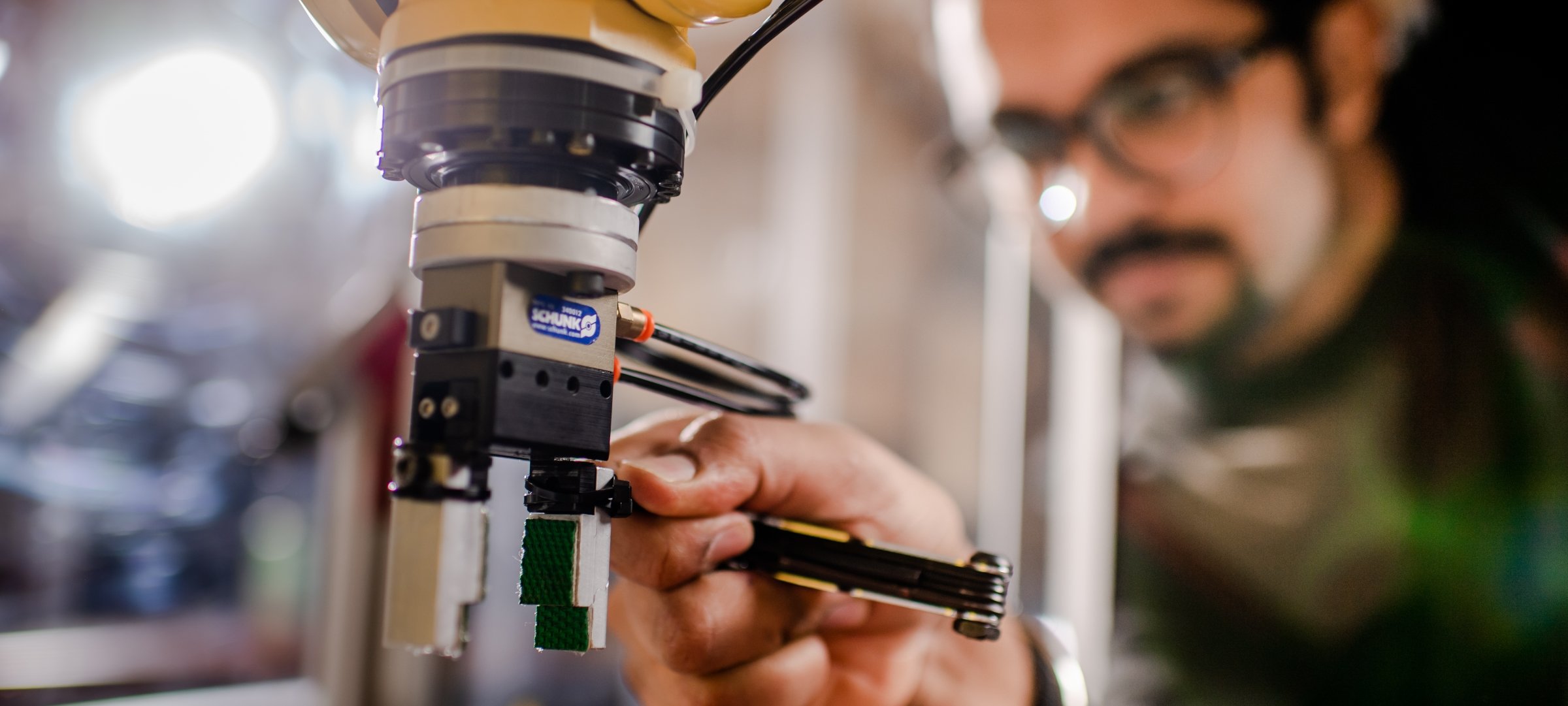 Grad student adjusting a piece of research equipment.