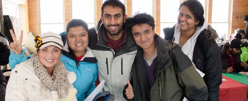 Students pose with Machel Borsum from International Programs and Services.