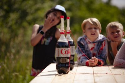 Mentos about to be dropped in bottles of coke