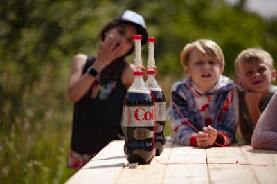 Mentos about to be dropped in bottles of coke