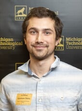 Abe Stone poses for a photo after winning an award