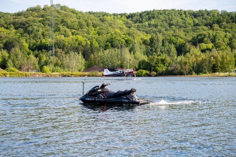 Autonomous Waverunner photobombed by the Isle Royale Seaplane on the Portage Canal by the Great Lakes Research Center