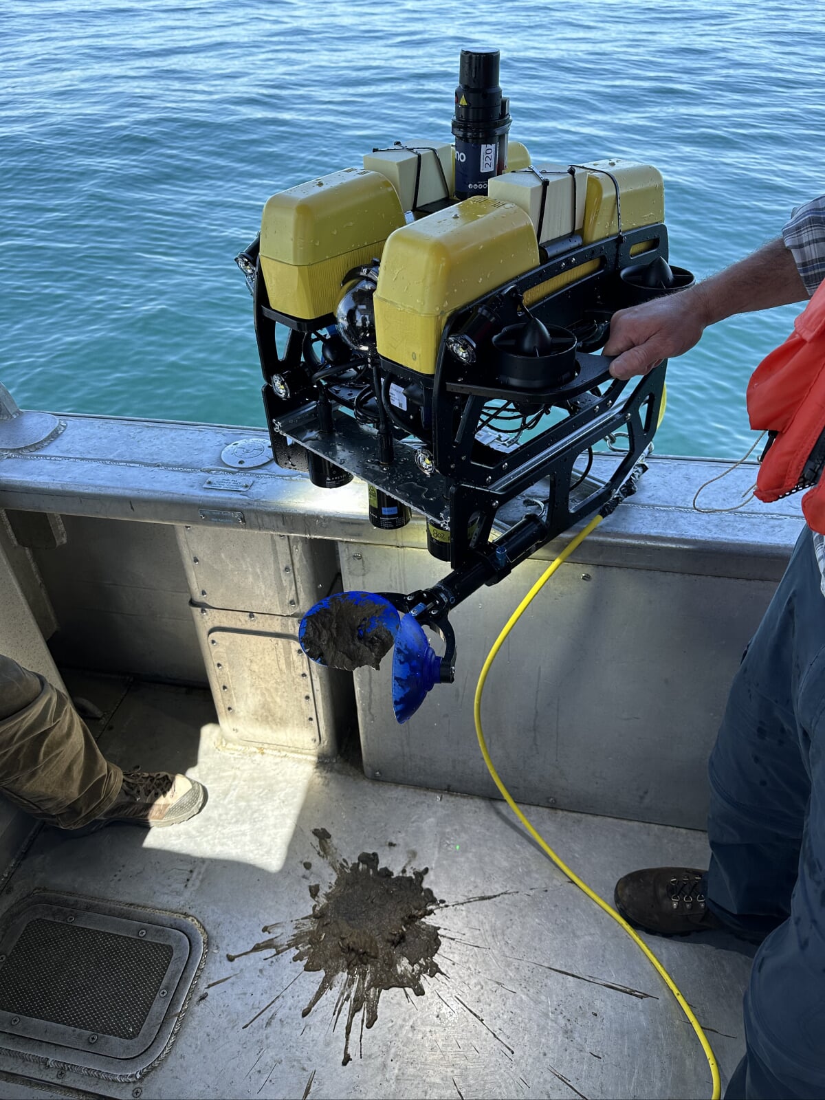 The Blue ROV2 Heavy sits on the side of a boat after dropping its mud sample from its collector.