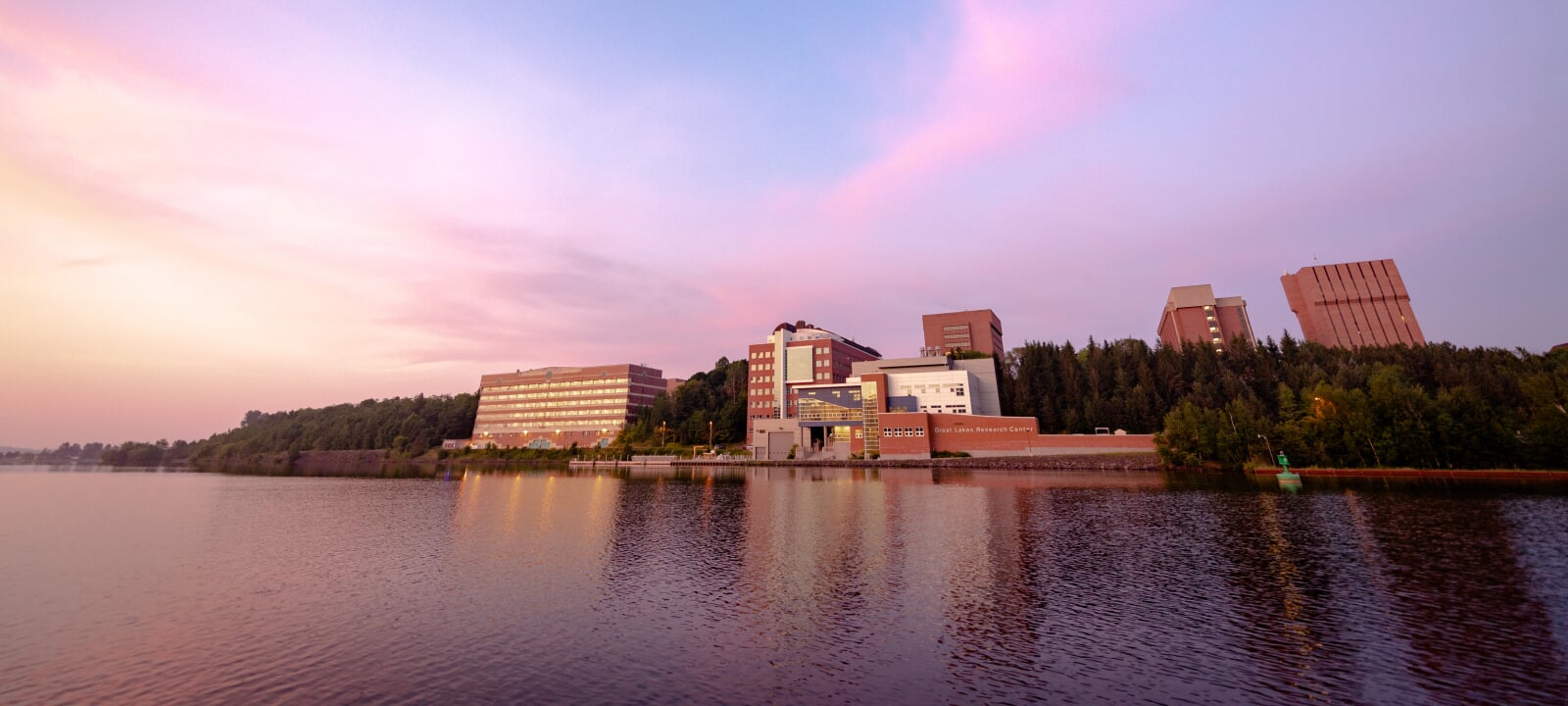 The Great Lakes Research Center (GLRC) building at sunrise from the waterway