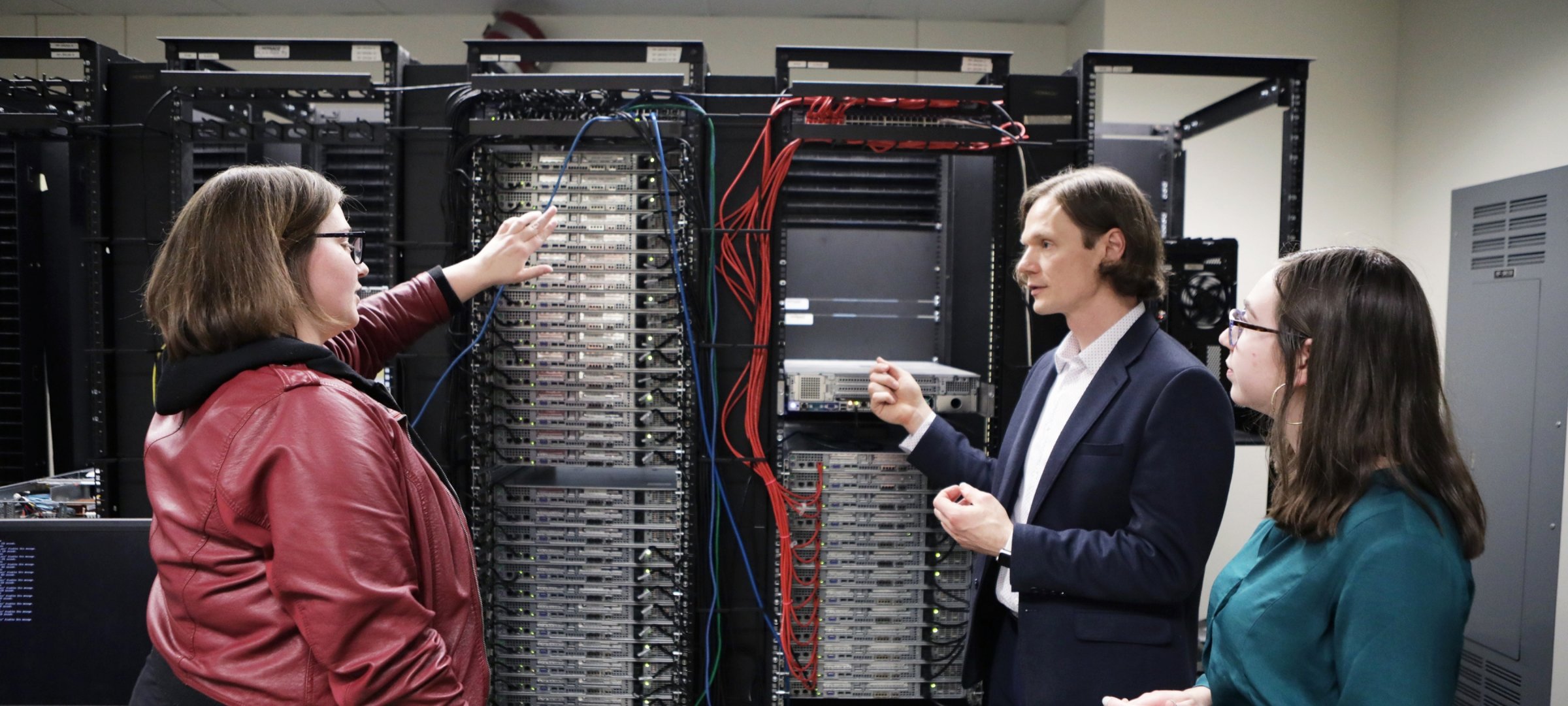 Prof. Guy Hembroff and Health Informatics graduate students look at a computer