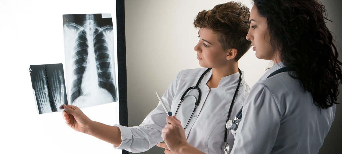 Two women examine x-rays
