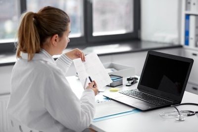 A woman works on a laptop computer.